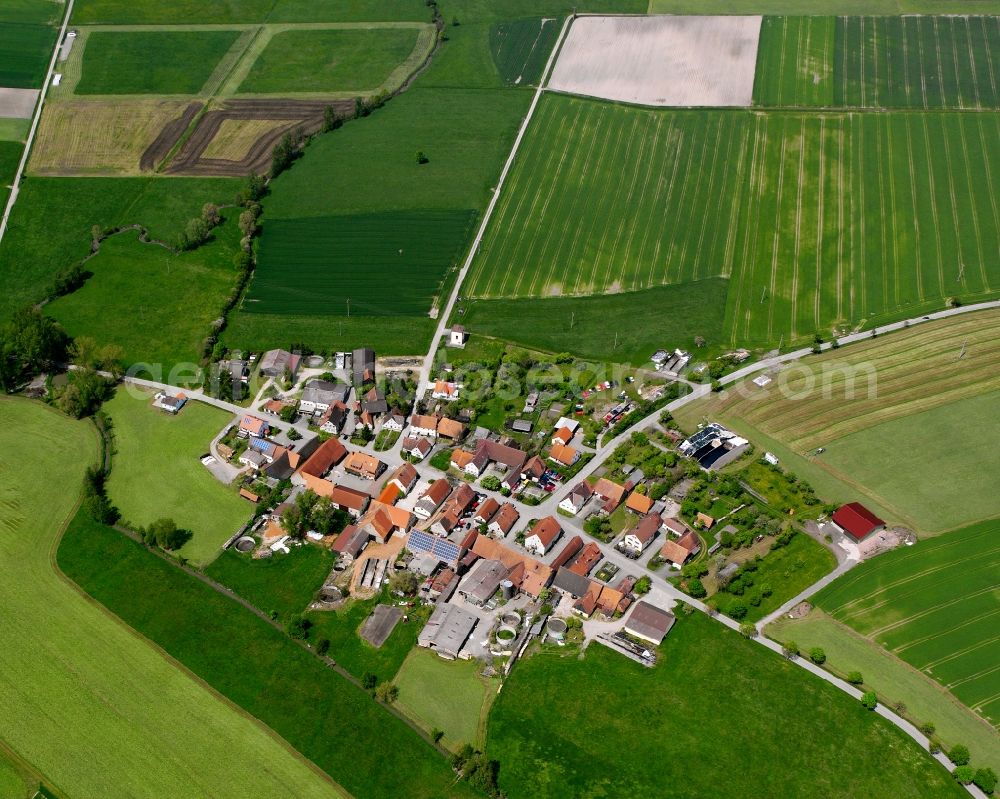 Oberfelden from above - Agricultural land and field boundaries surround the settlement area of the village in Oberfelden in the state Bavaria, Germany