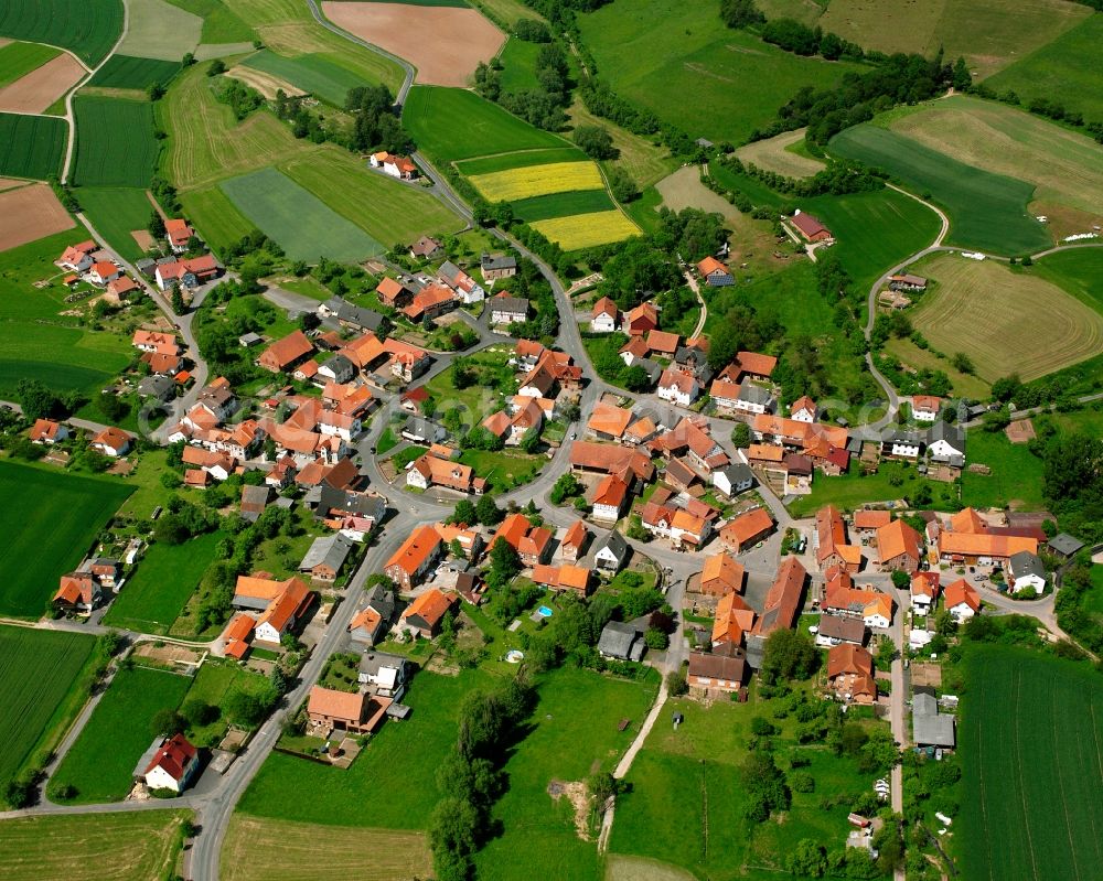 Obergude from the bird's eye view: Agricultural land and field boundaries surround the settlement area of the village in Obergude in the state Hesse, Germany