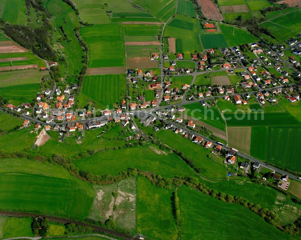 Aerial photograph Oberhaun - Agricultural land and field boundaries surround the settlement area of the village in Oberhaun in the state Hesse, Germany