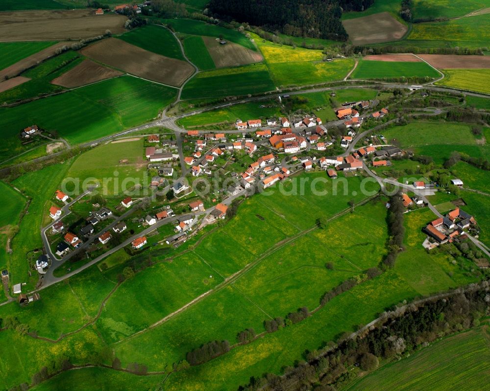 Oberjossa from the bird's eye view: Agricultural land and field boundaries surround the settlement area of the village in Oberjossa in the state Hesse, Germany