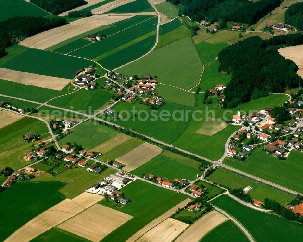 Oberkirchberg from the bird's eye view: Agricultural land and field boundaries surround the settlement area of the village in Oberkirchberg in the state Bavaria, Germany