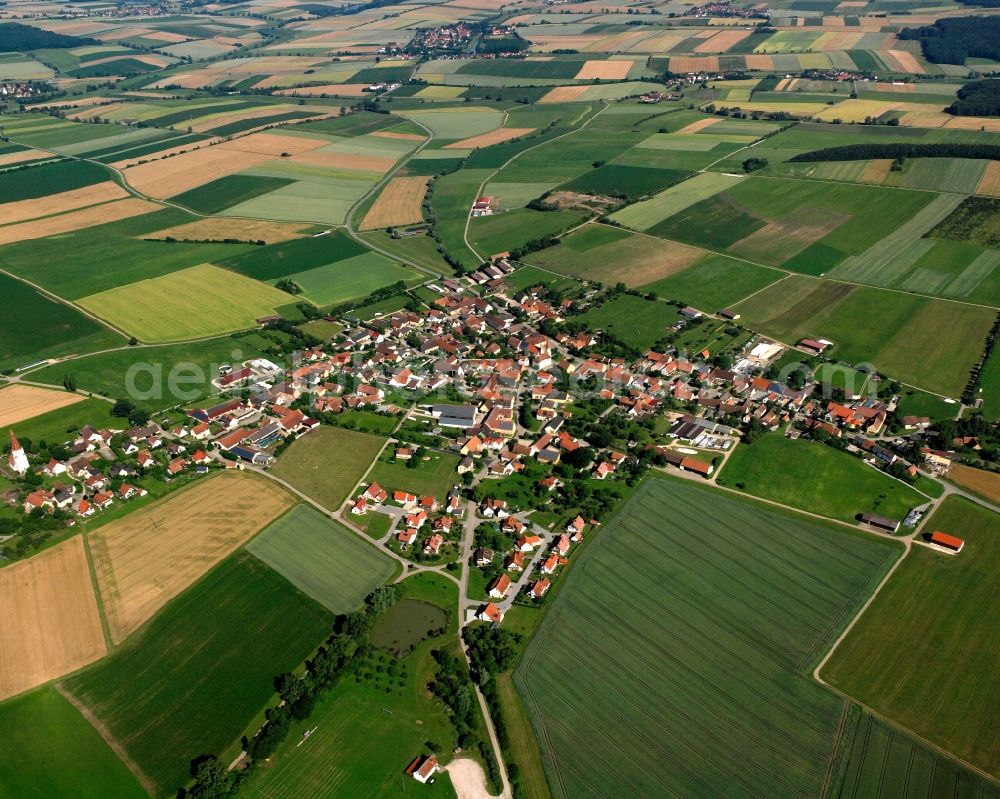 Obermögersheim from above - Agricultural land and field boundaries surround the settlement area of the village in Obermögersheim in the state Bavaria, Germany