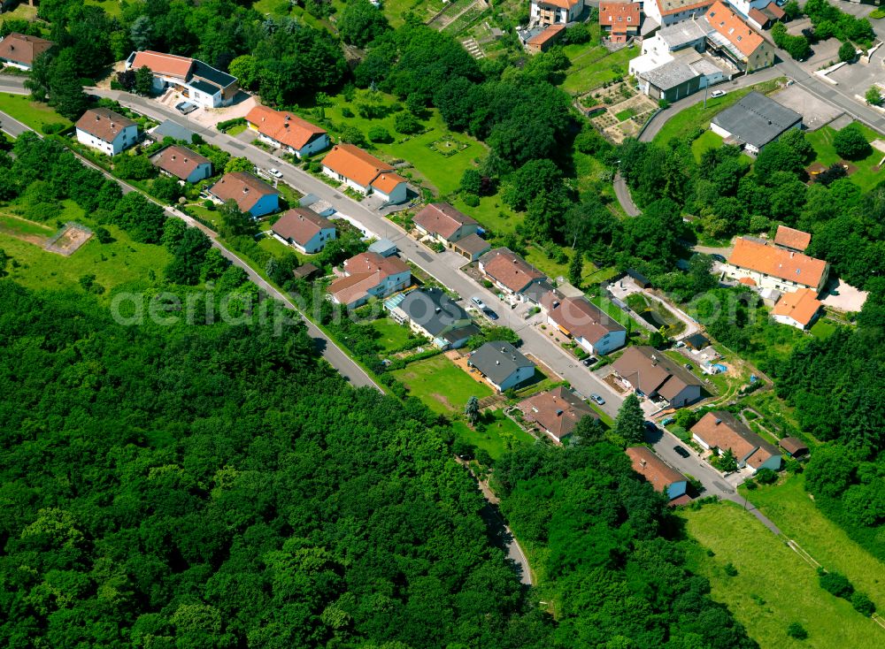 Obermoschel from above - Agricultural land and field boundaries surround the settlement area of the village in Obermoschel in the state Rhineland-Palatinate, Germany