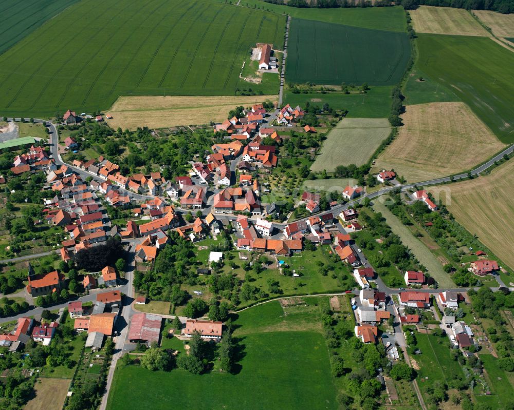 Oberorschel from the bird's eye view: Agricultural land and field boundaries surround the settlement area of the village in Oberorschel in the state Thuringia, Germany