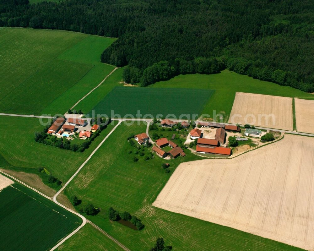 Oberreitzing from above - Agricultural land and field boundaries surround the settlement area of the village in Oberreitzing in the state Bavaria, Germany