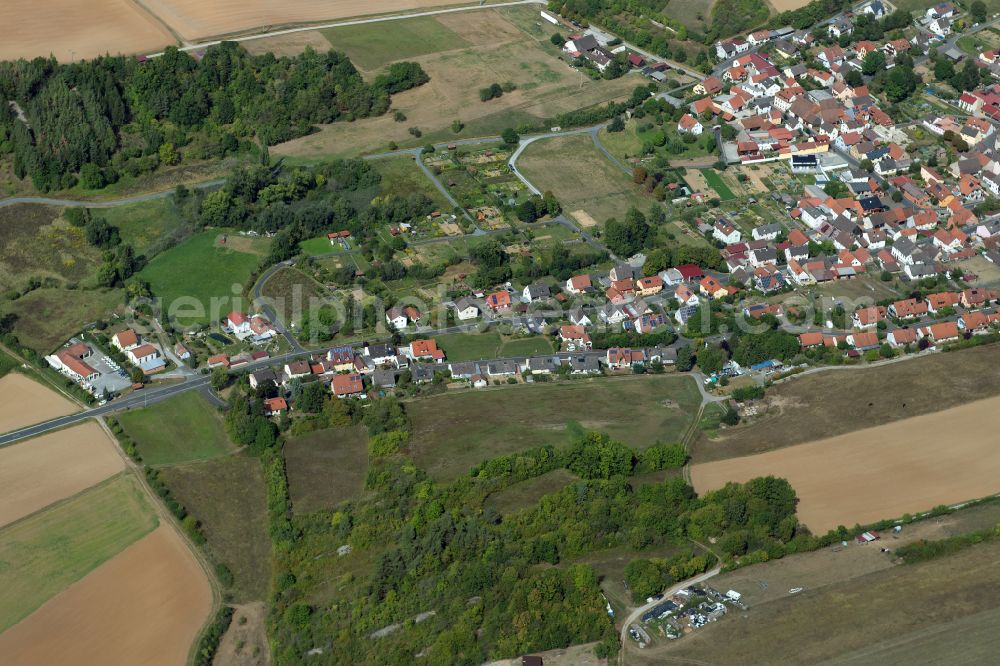 Obersfeld from the bird's eye view: Agricultural land and field boundaries surround the settlement area of the village in Obersfeld in the state Bavaria, Germany