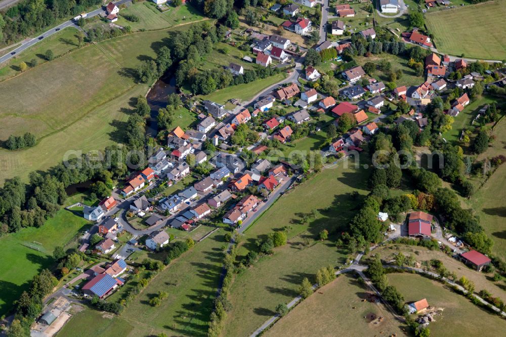 Aerial photograph Obersinn - Agricultural land and field boundaries surround the settlement area of the village in Obersinn in the state Bavaria, Germany