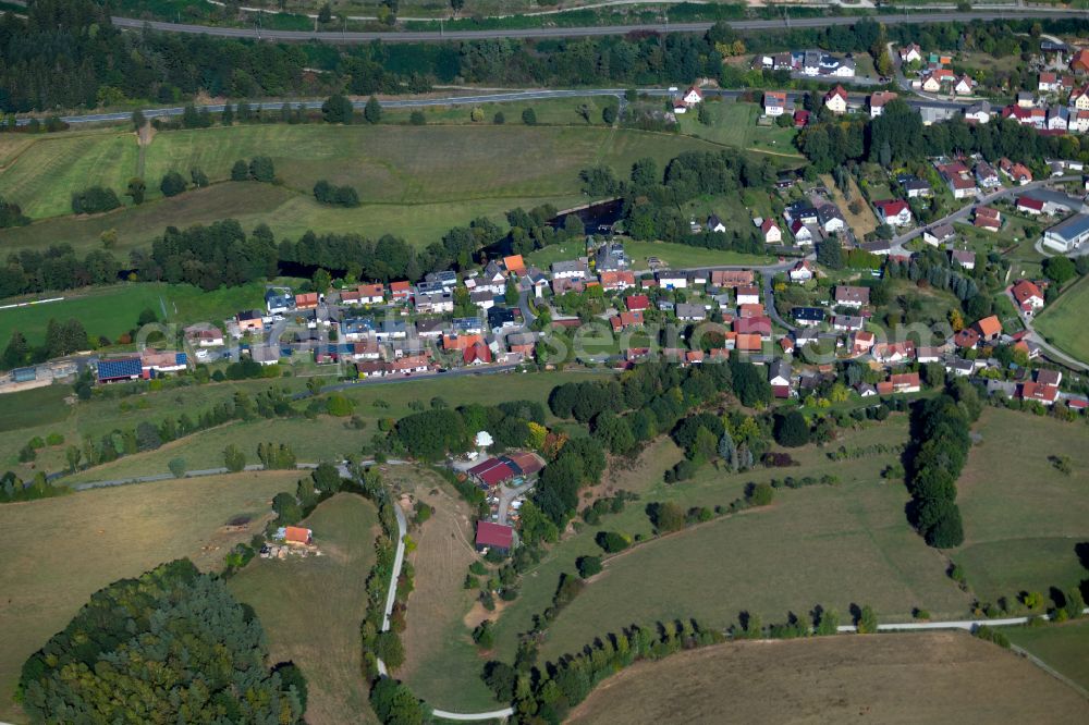 Obersinn from above - Agricultural land and field boundaries surround the settlement area of the village in Obersinn in the state Bavaria, Germany