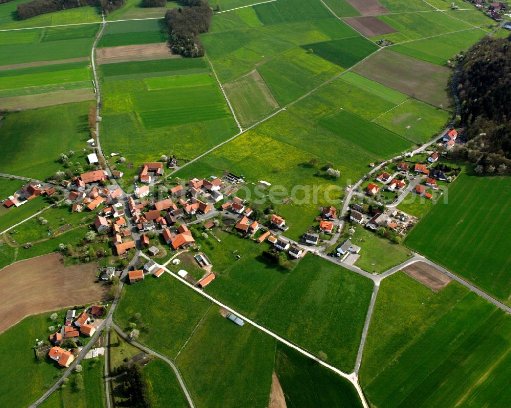 Oberstoppel from the bird's eye view: Agricultural land and field boundaries surround the settlement area of the village in Oberstoppel in the state Hesse, Germany