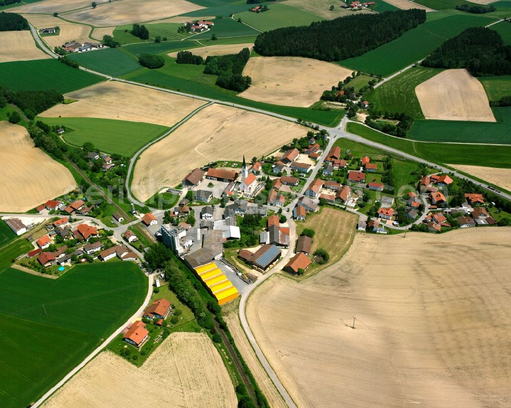 Obertrennbach from above - Agricultural land and field boundaries surround the settlement area of the village in Obertrennbach in the state Bavaria, Germany