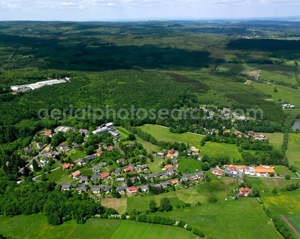 Aerial image Oberwald - Agricultural land and field boundaries surround the settlement area of the village in Oberwald in the state Hesse, Germany