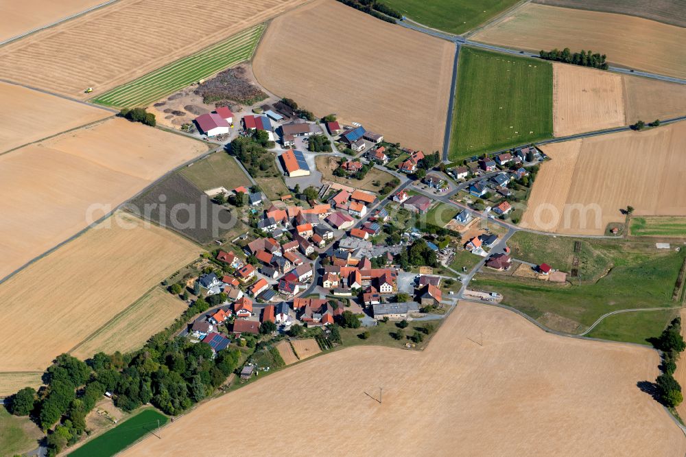 Oberwittbach from above - Agricultural land and field boundaries surround the settlement area of the village in Oberwittbach in the state Bavaria, Germany