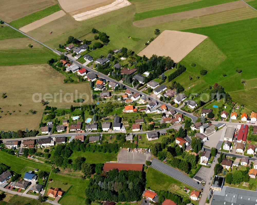 Oberzent from the bird's eye view: Agricultural land and field boundaries surround the settlement area of the village in Oberzent in the state Hesse, Germany