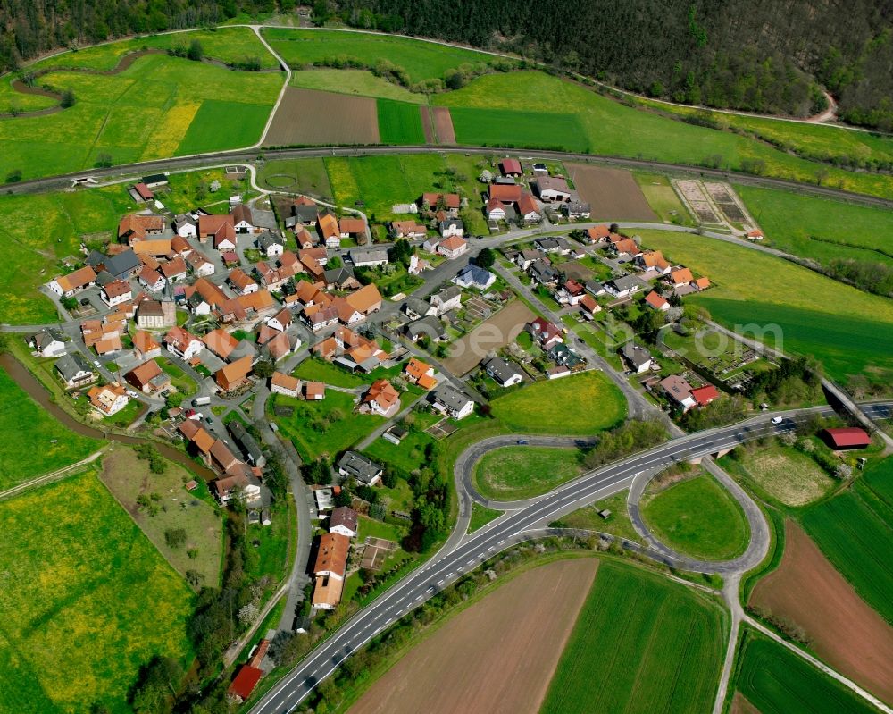 Aerial image Odensachsen - Agricultural land and field boundaries surround the settlement area of the village in Odensachsen in the state Hesse, Germany