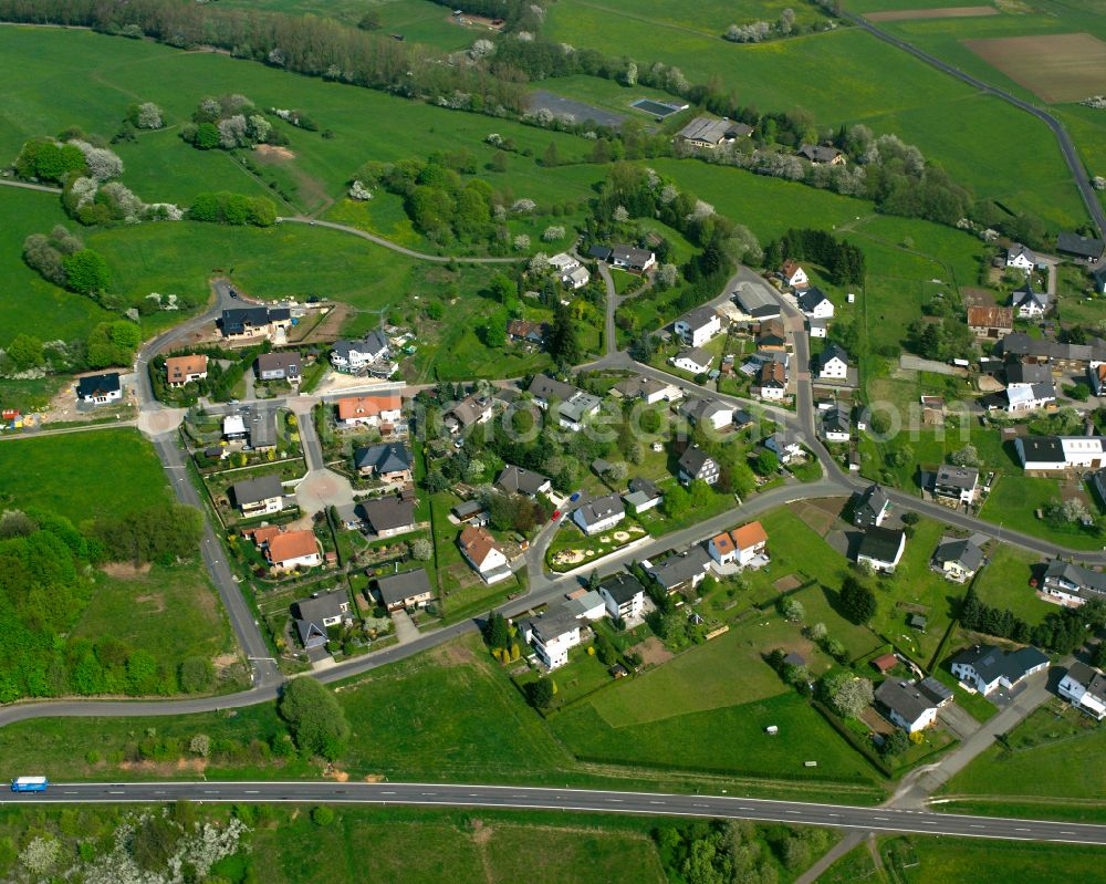 Odersberg from the bird's eye view: Agricultural land and field boundaries surround the settlement area of the village in Odersberg in the state Hesse, Germany