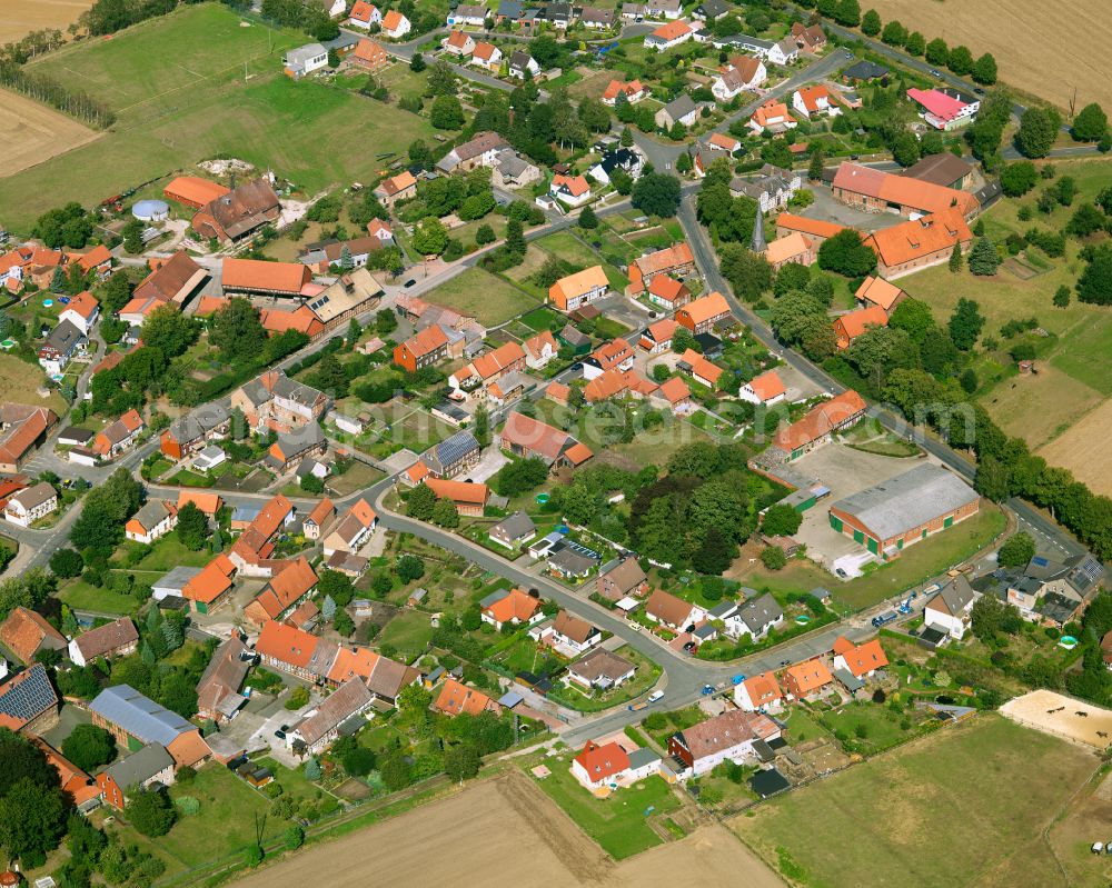 Ohlendorf from above - Agricultural land and field boundaries surround the settlement area of the village in Ohlendorf in the state Lower Saxony, Germany