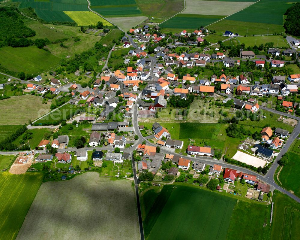 Aerial image Ohmes - Agricultural land and field boundaries surround the settlement area of the village in Ohmes in the state Hesse, Germany