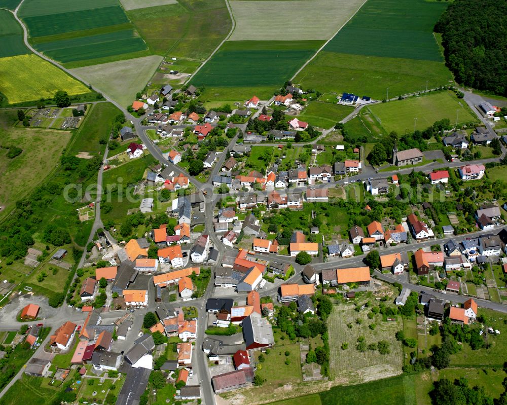 Aerial photograph Ohmes - Agricultural land and field boundaries surround the settlement area of the village in Ohmes in the state Hesse, Germany