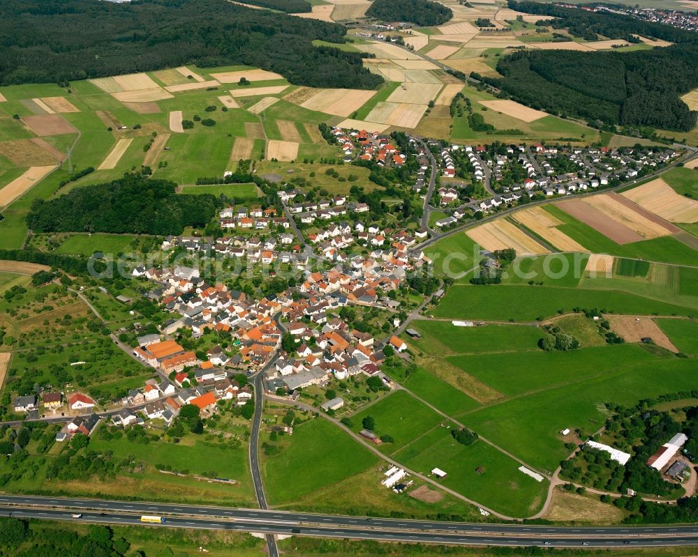 Oppenrod from the bird's eye view: Agricultural land and field boundaries surround the settlement area of the village in Oppenrod in the state Hesse, Germany