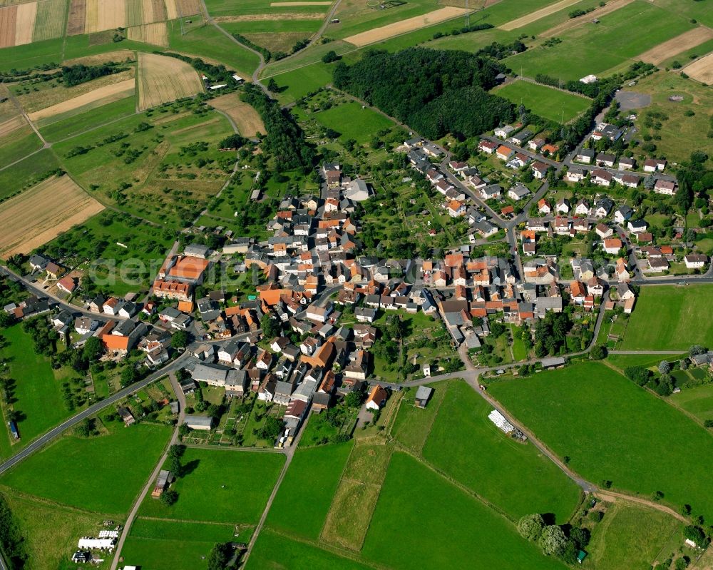 Aerial image Oppenrod - Agricultural land and field boundaries surround the settlement area of the village in Oppenrod in the state Hesse, Germany