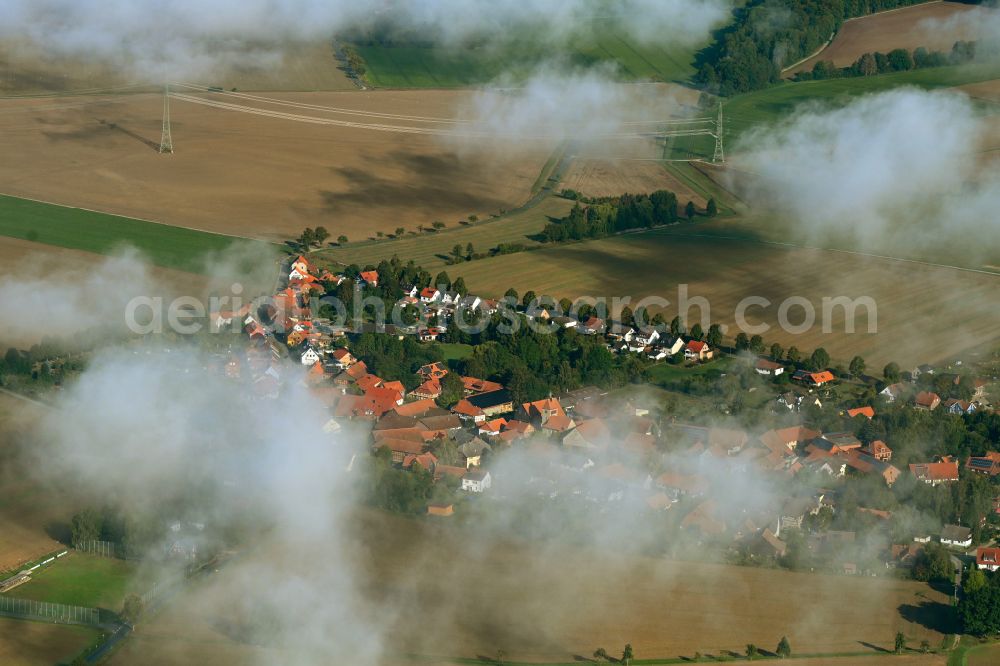 Orxhausen from above - Agricultural land and field boundaries surround the settlement area of the village in Orxhausen in the state Lower Saxony, Germany