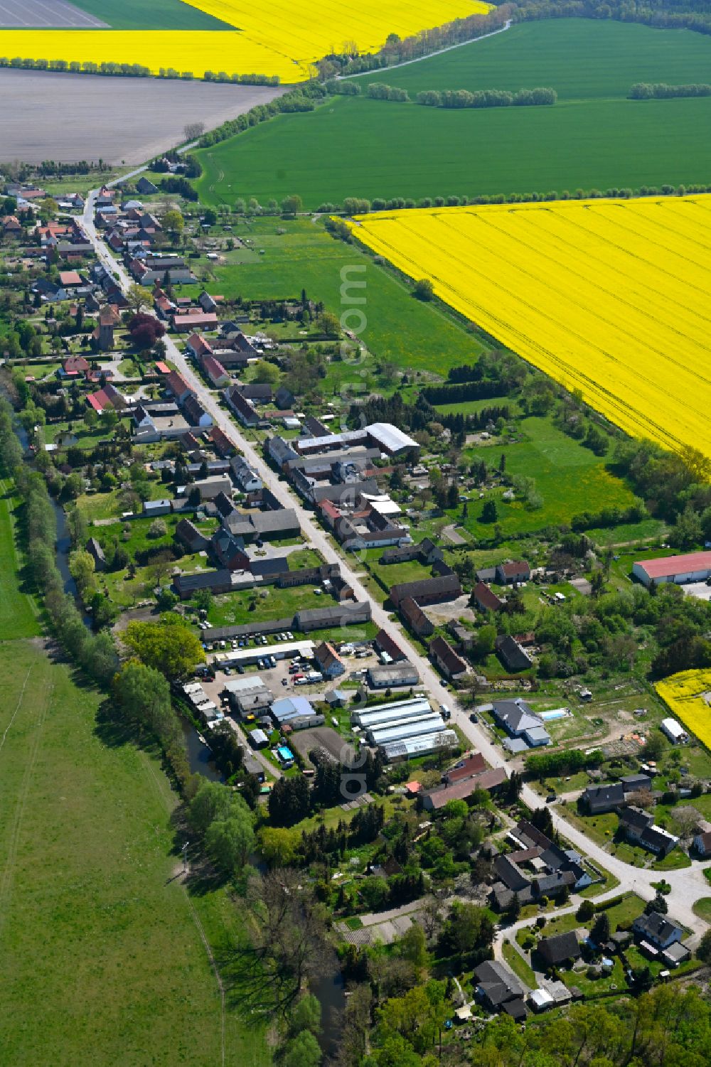 Osterburg (Altmark) from the bird's eye view: Agricultural land and field boundaries surround the settlement area of the village in Osterburg (Altmark) in the state Saxony-Anhalt, Germany