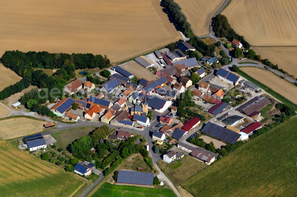 Aerial photograph Osthausen - Agricultural land and field boundaries surround the settlement area of the village in Osthausen in the state Bavaria, Germany