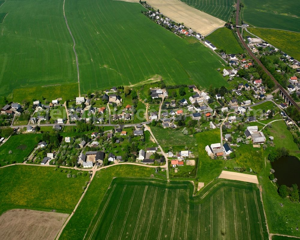 Ottendorf from the bird's eye view: Agricultural land and field boundaries surround the settlement area of the village in Ottendorf in the state Saxony, Germany