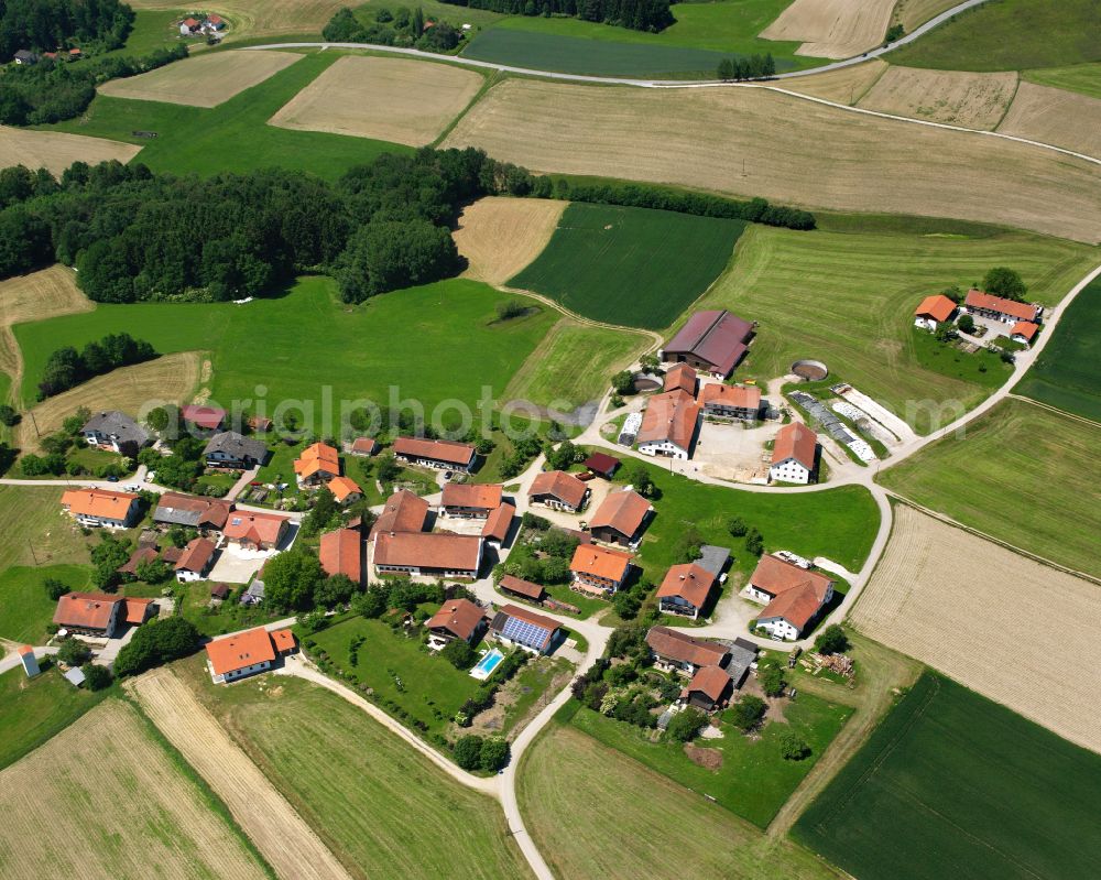 Petzlberg from the bird's eye view: Agricultural land and field boundaries surround the settlement area of the village in Petzlberg in the state Bavaria, Germany