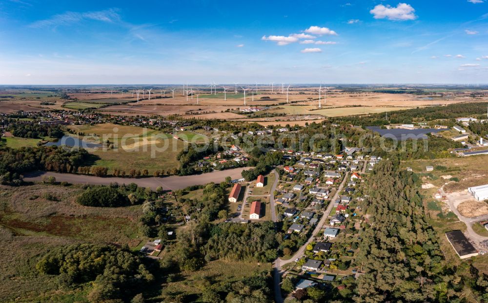 Pinnow from above - Agricultural land and field boundaries surround the settlement area of the village in Pinnow in the state Brandenburg, Germany