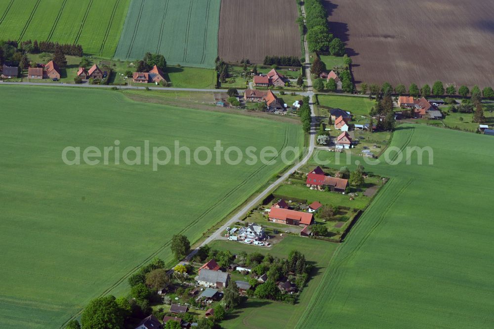 Pogreß from above - Agricultural land and field boundaries surround the settlement area of the village in Pogreß in the state Mecklenburg - Western Pomerania, Germany