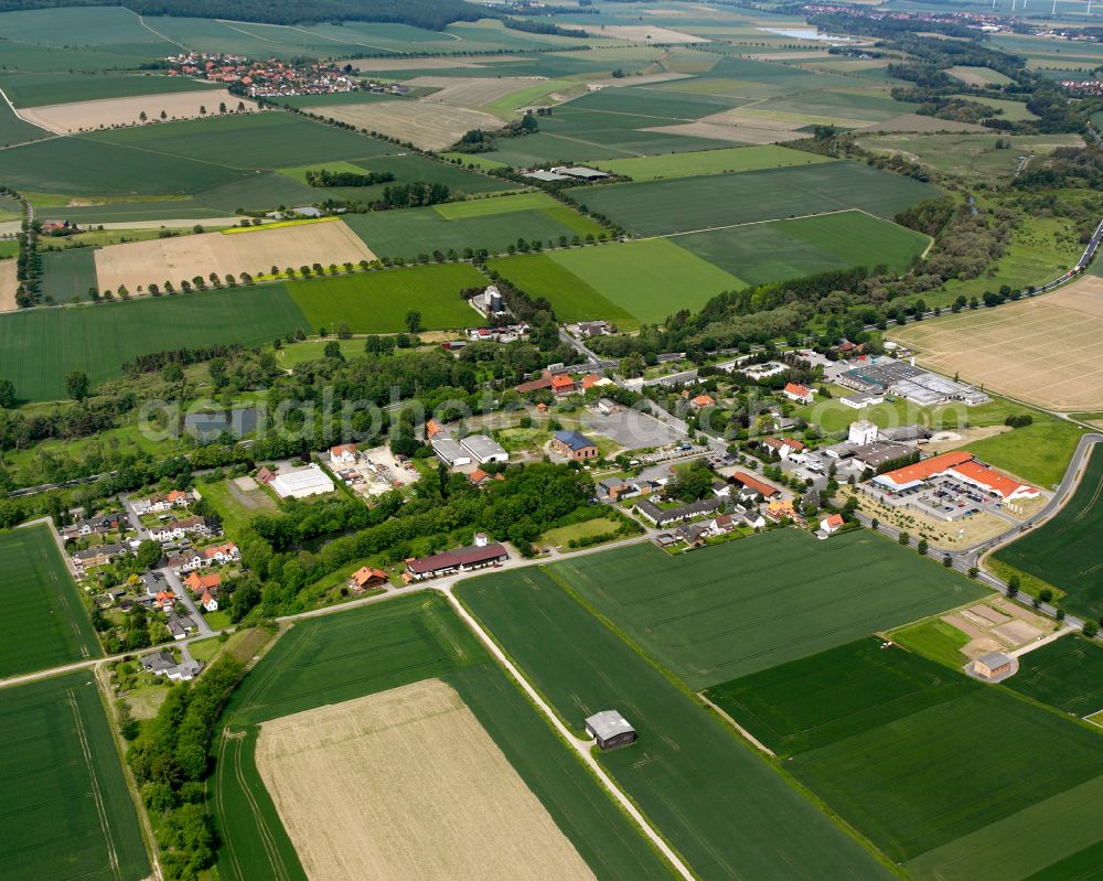 Posthof from above - Agricultural land and field boundaries surround the settlement area of the village in Posthof in the state Lower Saxony, Germany