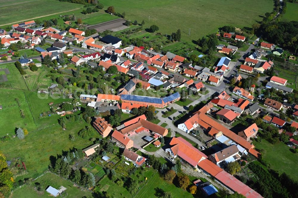 Potzehne from above - Agricultural land and field boundaries surround the settlement area of the village in Potzehne in the state Saxony-Anhalt, Germany