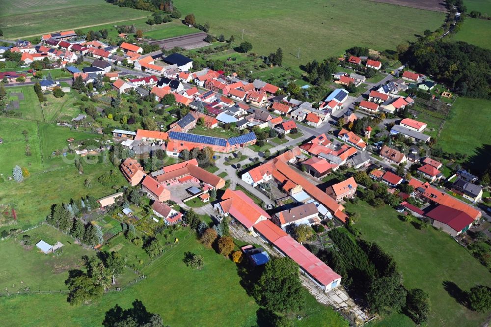 Potzehne from above - Agricultural land and field boundaries surround the settlement area of the village in Potzehne in the state Saxony-Anhalt, Germany