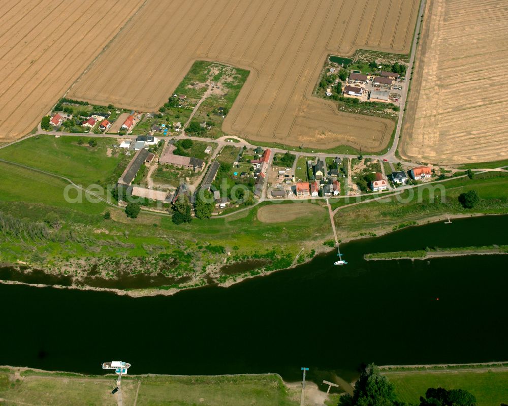 Promnitz from the bird's eye view: Agricultural land and field boundaries surround the settlement area of the village in Promnitz in the state Saxony, Germany