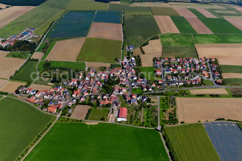 Aerial image Püssensheim - Agricultural land and field boundaries surround the settlement area of the village in Püssensheim in the state Bavaria, Germany