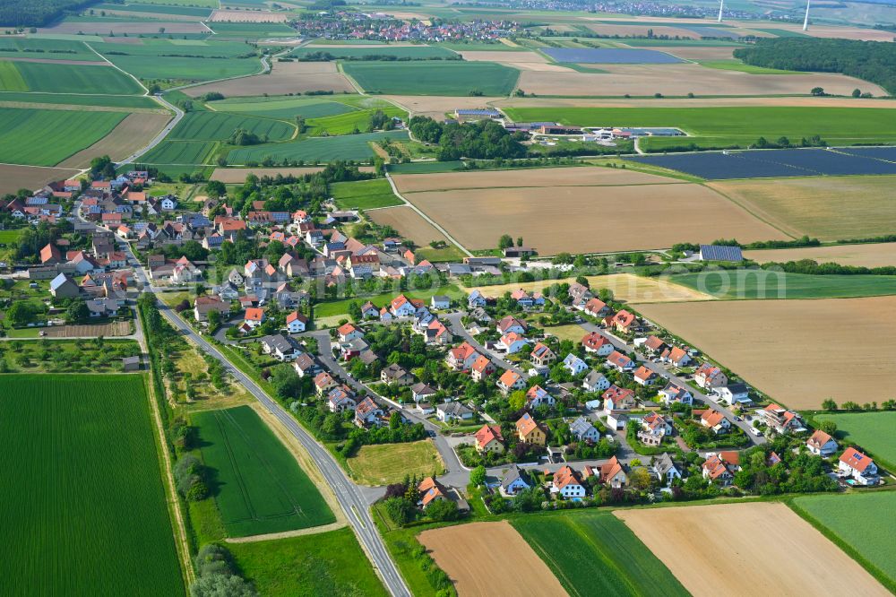 Aerial photograph Püssensheim - Agricultural land and field boundaries surround the settlement area of the village in Püssensheim in the state Bavaria, Germany