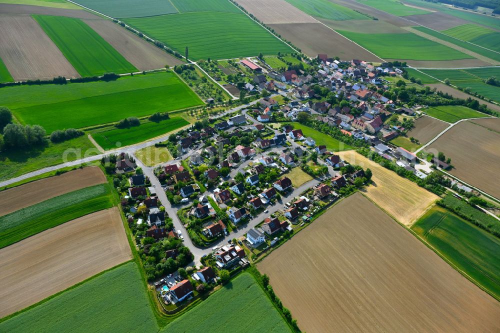 Püssensheim from the bird's eye view: Agricultural land and field boundaries surround the settlement area of the village in Püssensheim in the state Bavaria, Germany