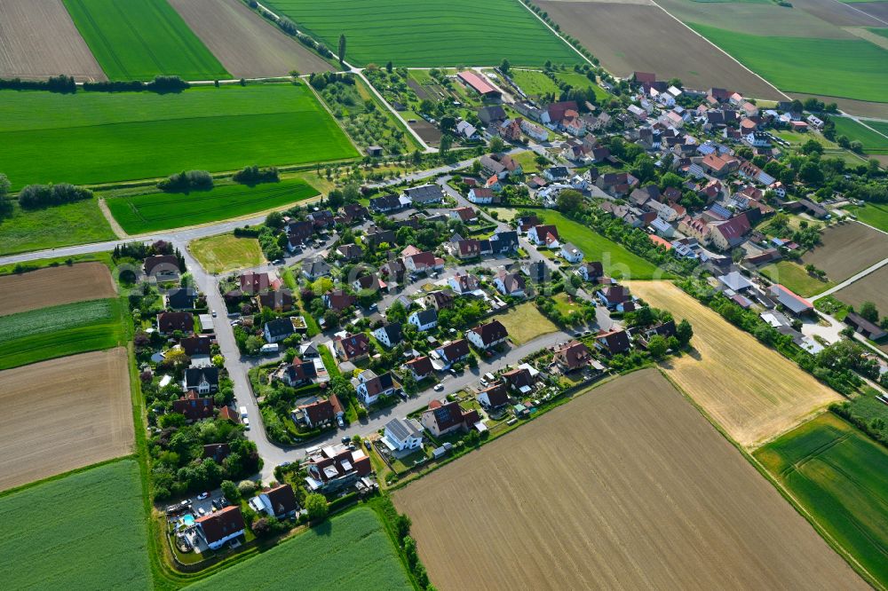 Aerial image Püssensheim - Agricultural land and field boundaries surround the settlement area of the village in Püssensheim in the state Bavaria, Germany