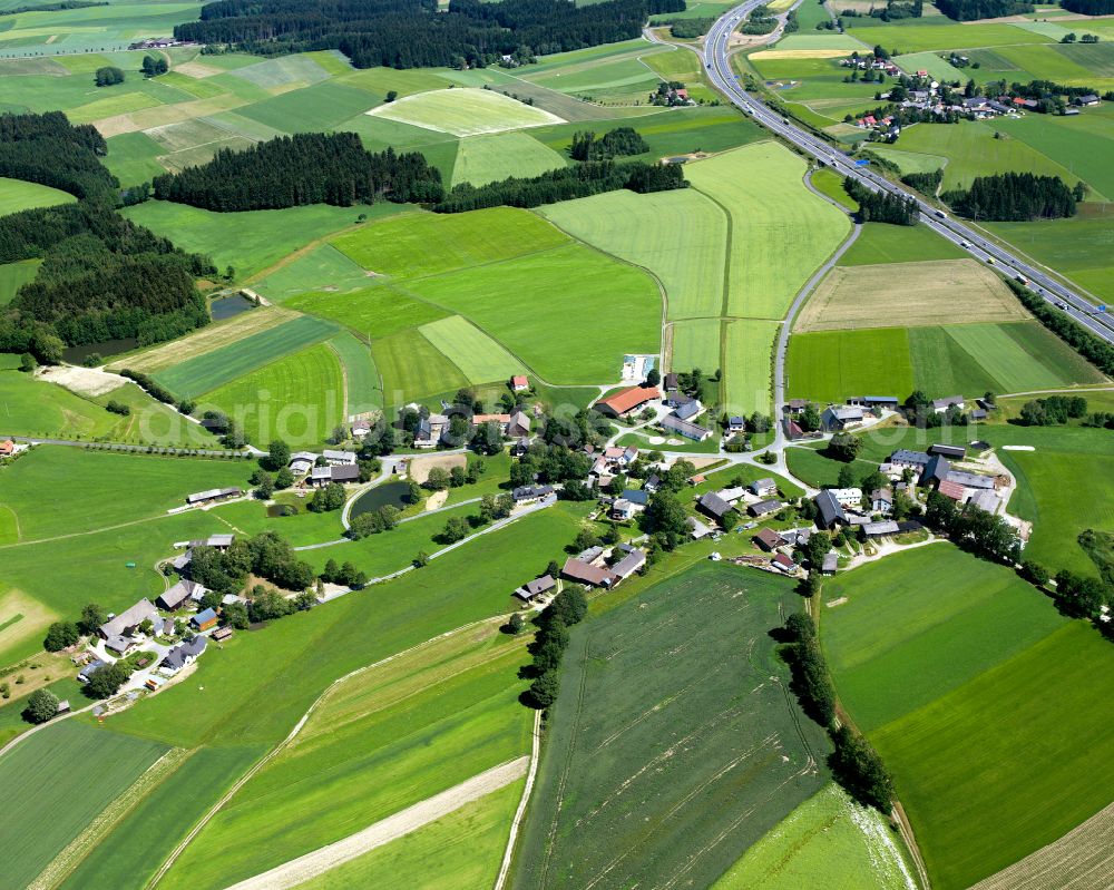 Querenbach from above - Agricultural land and field boundaries surround the settlement area of the village in Querenbach in the state Bavaria, Germany