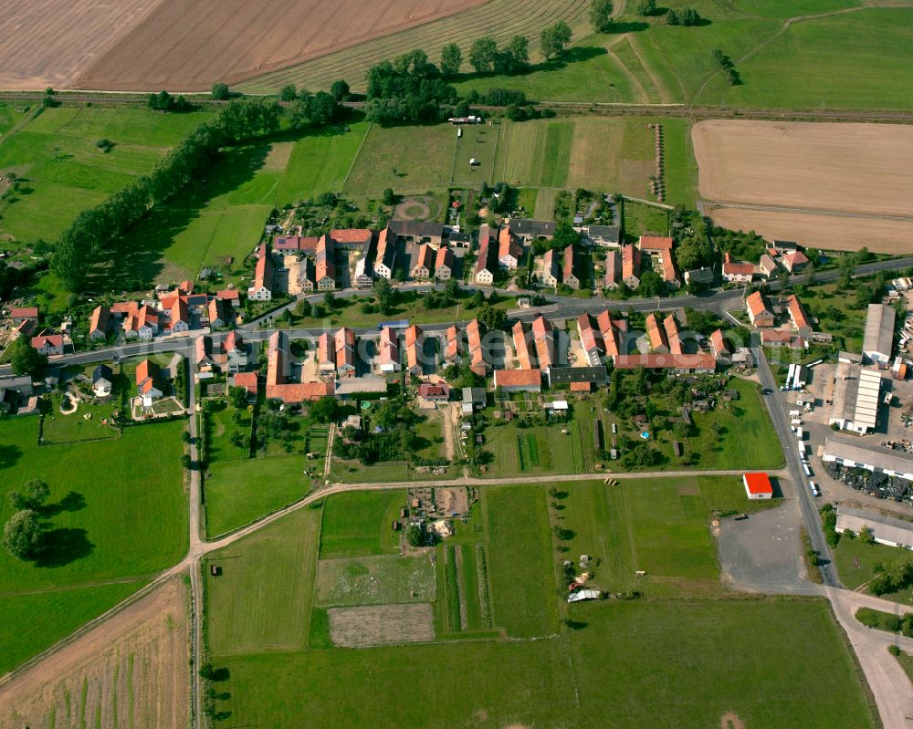 Aerial photograph Quersa - Agricultural land and field boundaries surround the settlement area of the village in Quersa in the state Saxony, Germany