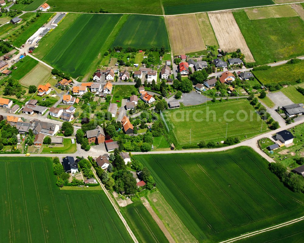 Aerial photograph Rainrod - Agricultural land and field boundaries surround the settlement area of the village in Rainrod in the state Hesse, Germany