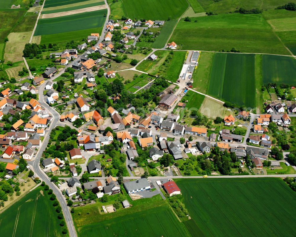 Rainrod from above - Agricultural land and field boundaries surround the settlement area of the village in Rainrod in the state Hesse, Germany