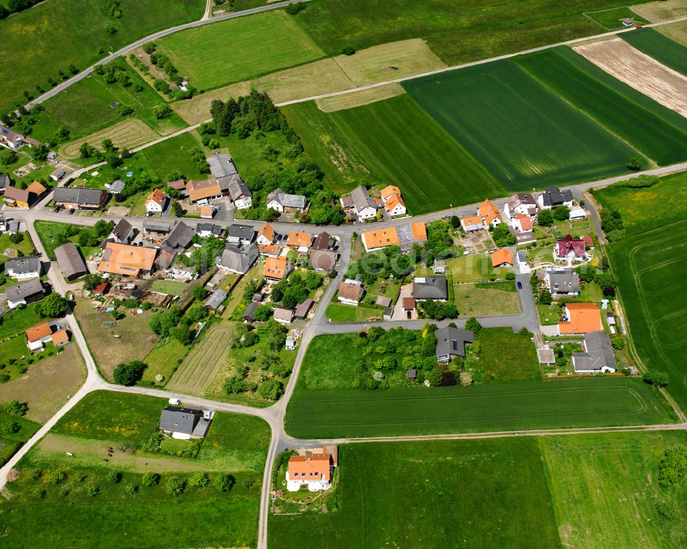 Rainrod from the bird's eye view: Agricultural land and field boundaries surround the settlement area of the village in Rainrod in the state Hesse, Germany