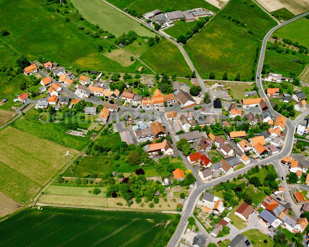 Aerial image Rainrod - Agricultural land and field boundaries surround the settlement area of the village in Rainrod in the state Hesse, Germany