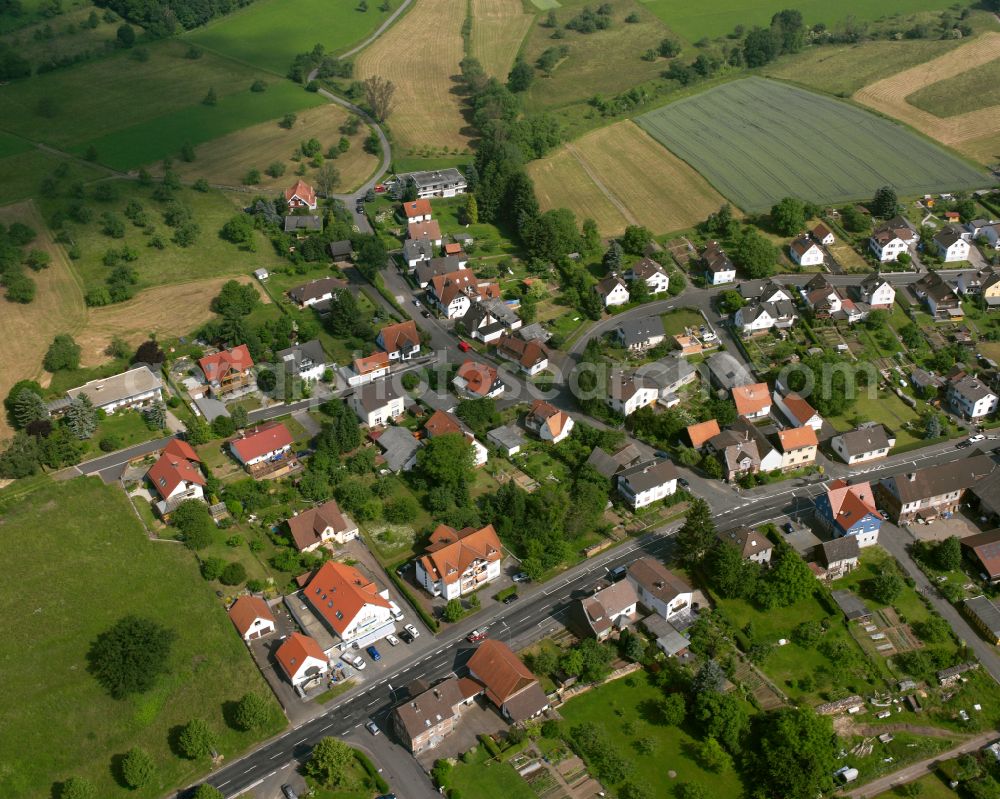 Rainrod from above - Agricultural land and field boundaries surround the settlement area of the village in Rainrod in the state Hesse, Germany