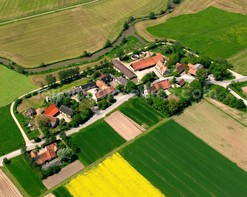 Rauenbuch from above - Agricultural land and field boundaries surround the settlement area of the village in Rauenbuch in the state Bavaria, Germany