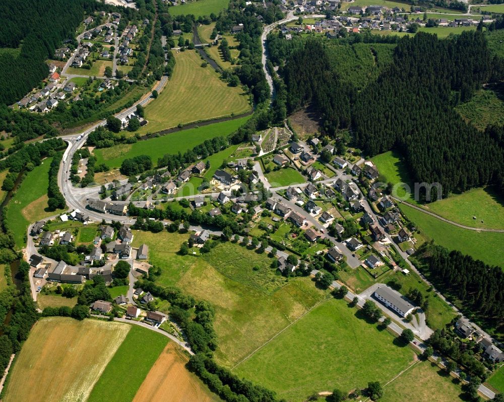 Raumland from above - Agricultural land and field boundaries surround the settlement area of the village in Raumland in the state North Rhine-Westphalia, Germany