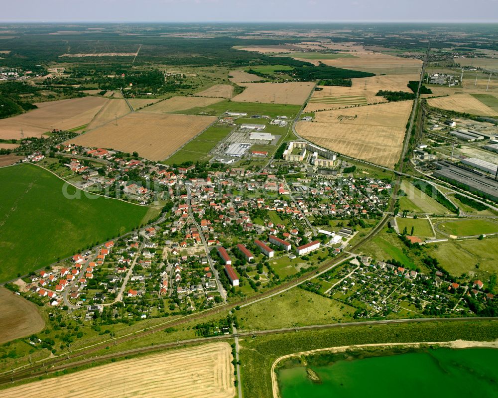 Röderau-Bobersen from the bird's eye view: Agricultural land and field boundaries surround the settlement area of the village in Röderau-Bobersen in the state Saxony, Germany