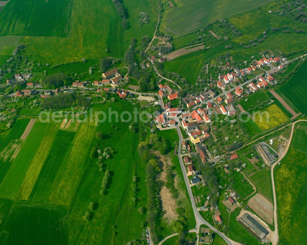 Aerial image Rüdersdorf - Agricultural land and field boundaries surround the settlement area of the village in Ruedersdorf in the state Thuringia, Germany